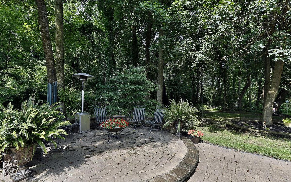 Landscaped paver patio with fire pit backing to woods in the Woodmore area of Bowie, Maryland